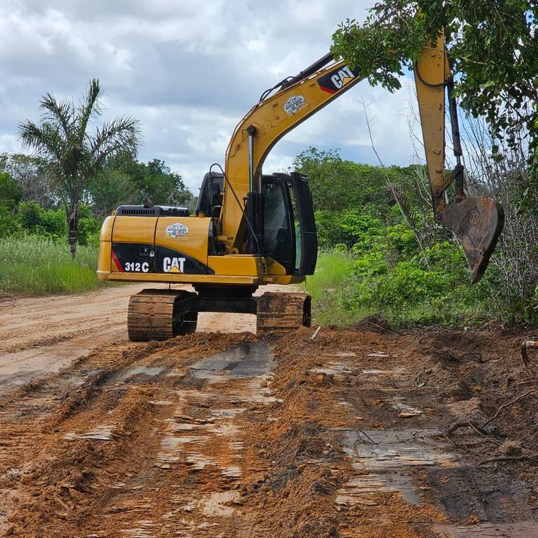 CAT 312C excavator clearing bush along a roadway